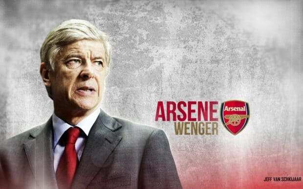 A middle-aged man with gray hair in a suit and red tie, looking serious, with Arsenal Football Club logo and text in the background.