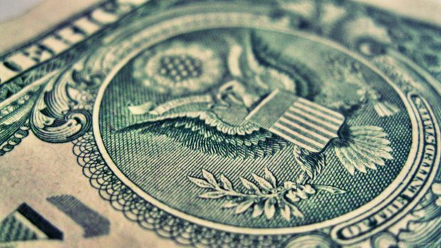 Usa coat of arms on money background.