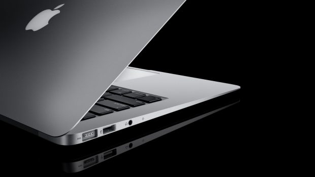 Laptop apple white black open reflection.