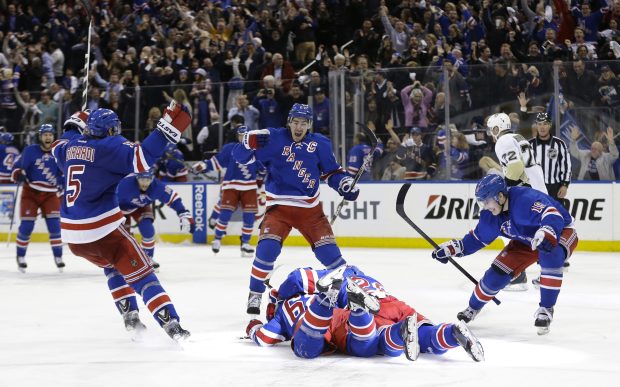 New York Rangers players celebrate after beating the Pittsburgh Penguins 2-1