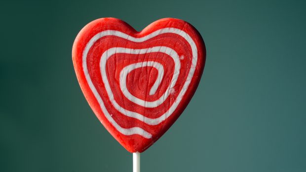 Red and white heart shaped lollipop wallpapers.