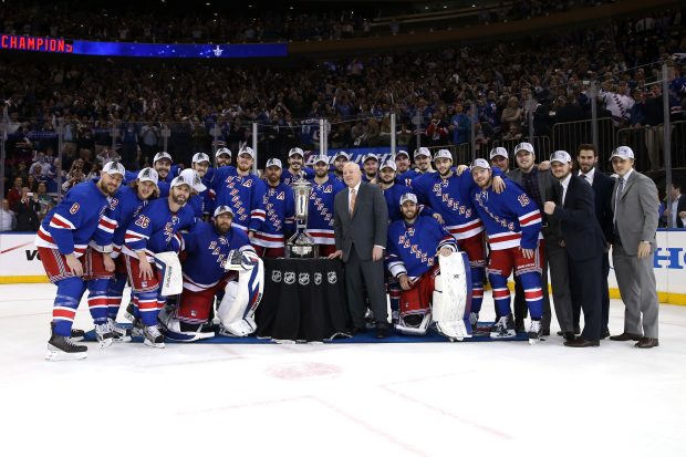 The New York Rangers pose with Deputy Commissioner Bill Daly and the Prince of Wales Trophy.