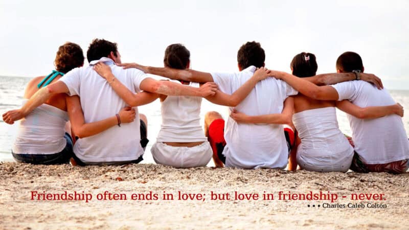 Friends friendship friendship at the beach group of friends sitting together on the sand enjoying the ocean view.