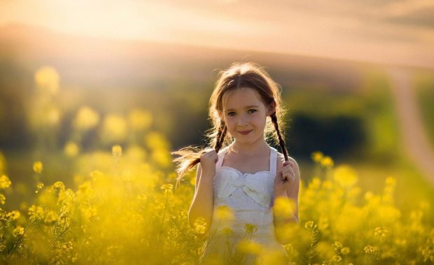 Cute Baby Girl in Yellow Flowers Field HD Desktop Pictures.