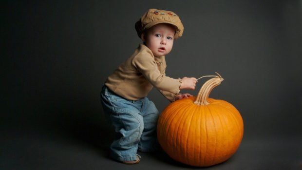 Images the boy with pumpkin.