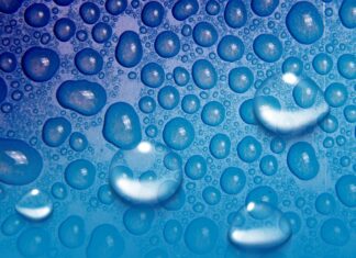 Blue water droplets on surface.