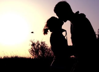 Couple shadow sunset kissing.