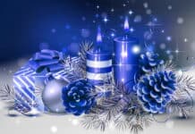 Blue Christmas candles with ornaments, pinecones, and gift box, festive holiday decoration for winter season.