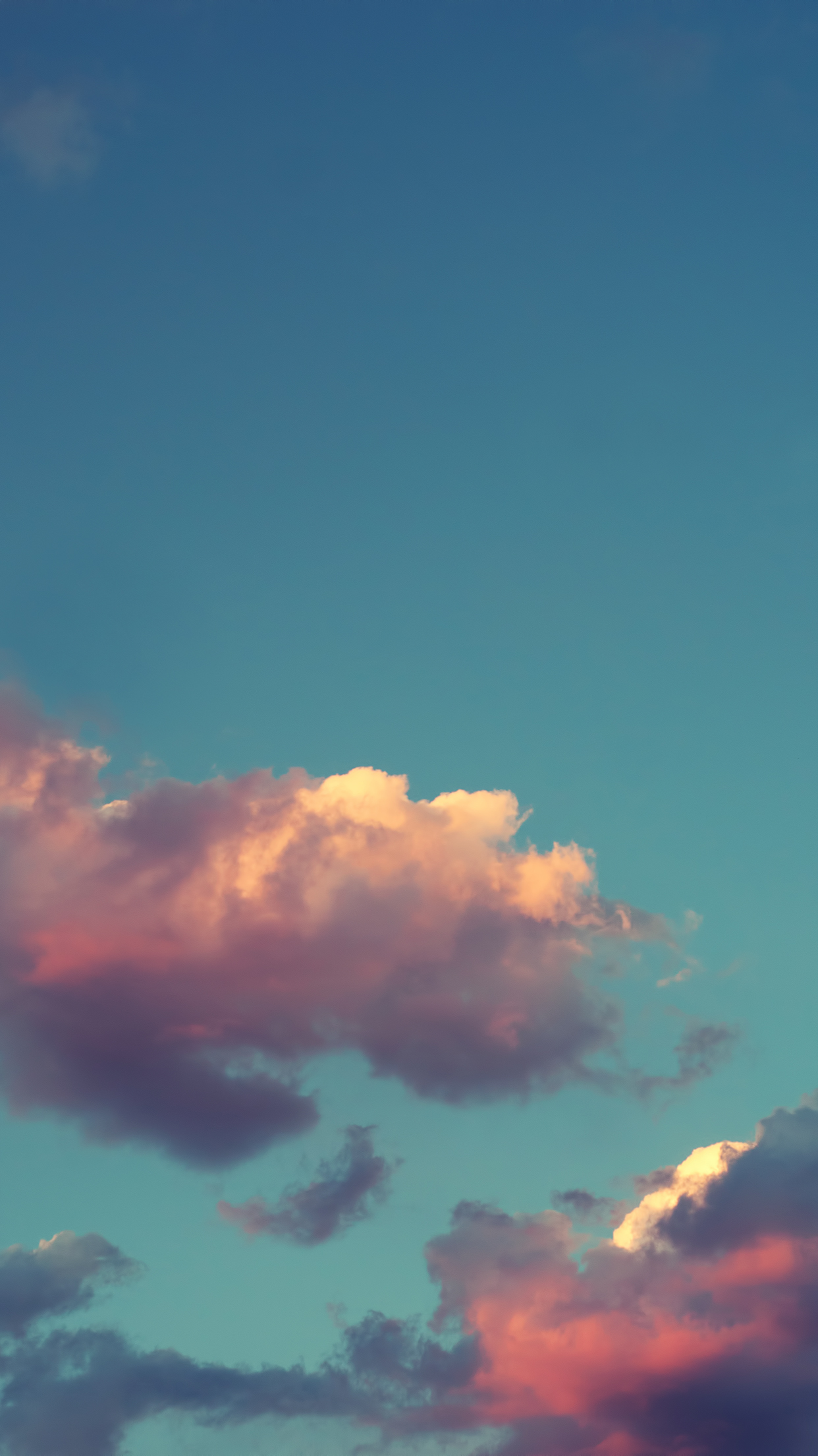 A beautiful image of clouds in various shades of white and grey, seen from the sky