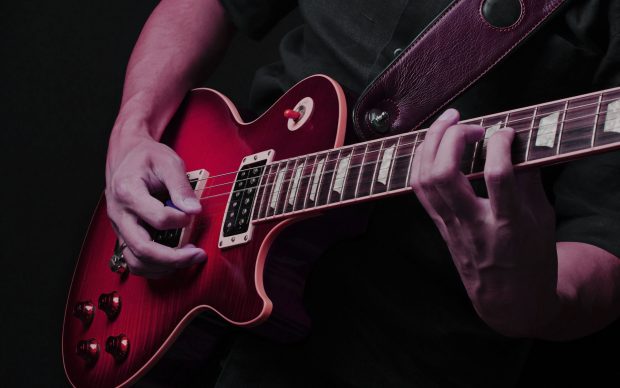 Images artist playing electric guitar.