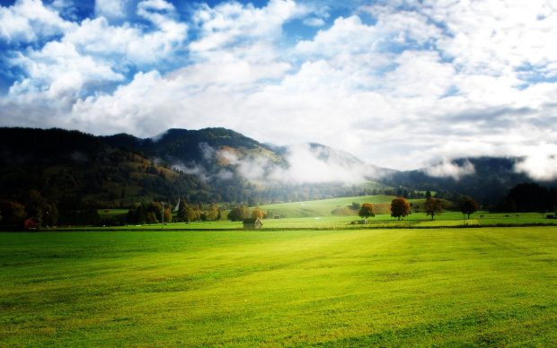 Nature wallpaper background mountains grass clouds.