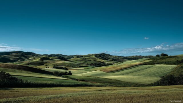 Best Wallpaper For Desktop, A Captivating Landscape Featuring Rolling Hills And Fields Under A Clear Blue Sky In High Resolution