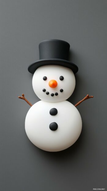 Cute snowman decoration with orange carrot nose and black buttons on gray background