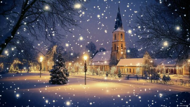 A winter Christmas scene with snow falling over a church and decorated trees in the snow