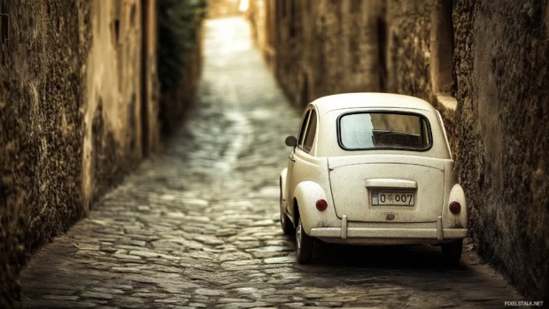 A retro Fiat 500 driving through a narrow cobblestone street, framed in an aged Polaroid style with vintage filters.