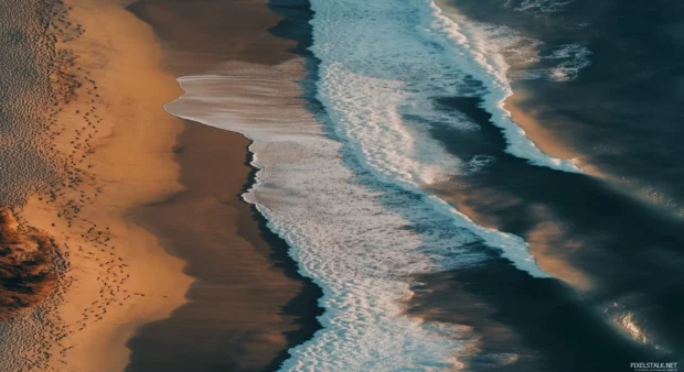 An aesthetic beach scene with delicate footprints in the sand.