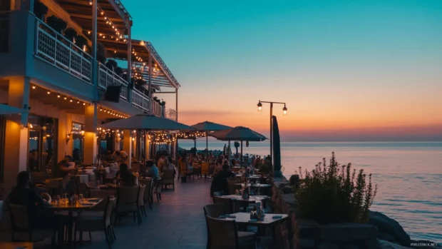 A beach restaurant with soft lighting, ocean views, and outdoor seating at sunrise.