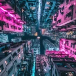 A bright Cyberpunk skyline featuring neon lit buildings and crowded roads under colorful lights.
