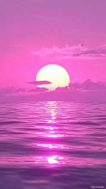 A bright pink purple sky on ocean, final sun rays vanish.