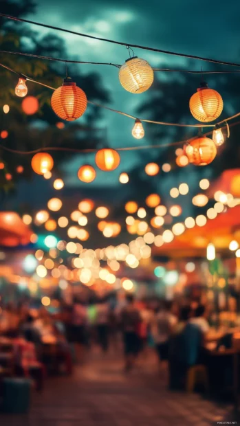 A bustling street market at night with colorful string lights and glowing lanterns creating a festive atmosphere.