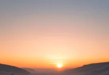 A calm valley covered in misty sunrise nature phone wallpaper.