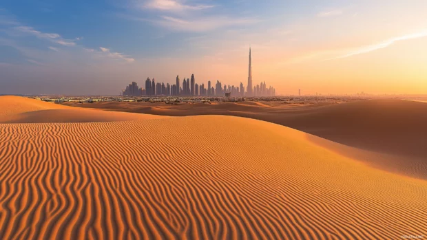 A clear Dubai desert view, skyline silhouette in the distance.