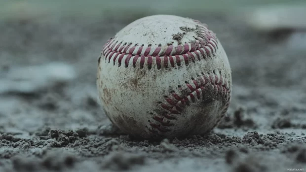 A close up of a scuffed baseball resting on home plate captured in Baseball field wallpaper for Macbook.