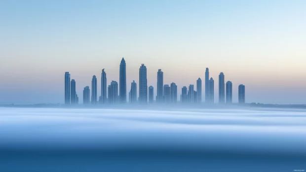 A coastal city skyline with light clouds in the background.