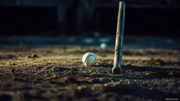 A dramatic shot of a baseball bat and ball arranged neatly on a pitchers mound with details reflecting Baseball bat with ball wallpaper.