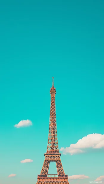 A minimalist view of the Eiffel Tower against a clear blue sky.
