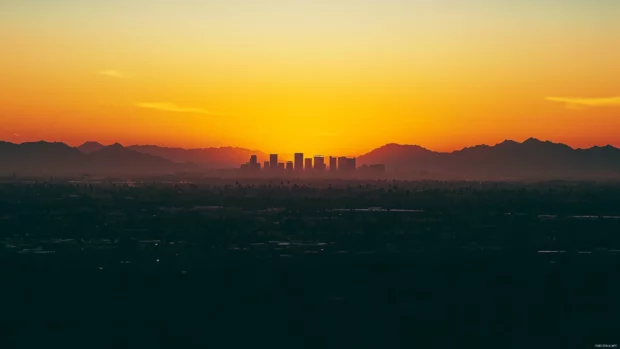 A new day begins as sunrise glows over the urban jungle.