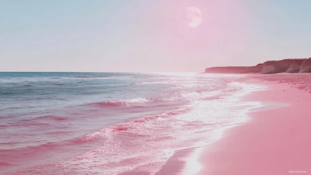 A pink beach with a pink moon and pink ocean reflecting moonlight.