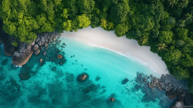 A pristine beach with crystal clear turquoise waters and white sand.