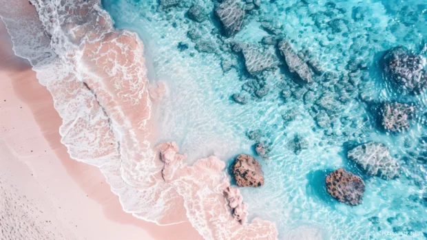 A pristine beach with crystal clear turquoise waters and white sand.