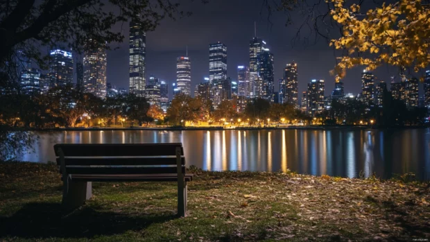 A quiet park bench overlooks the shimmering towers of the night city.