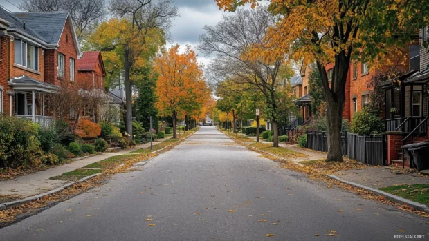 A quiet residential street in the city lined with trees and historic houses.