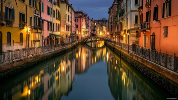 A quiet river running through the city at night, with reflections of buildings and bridges in the water.