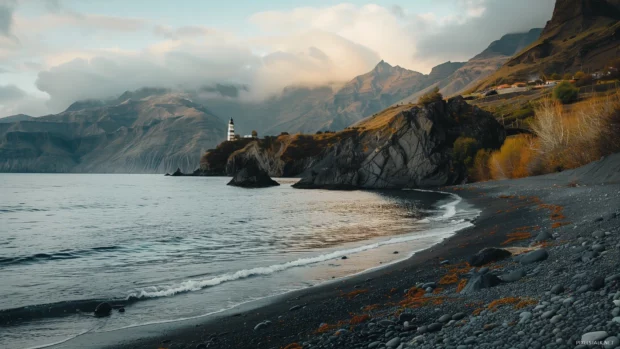 A rocky promontory with a lighthouse overlooking the beach.