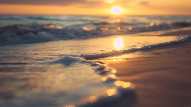 A serene sunset beach with gentle waves and golden sand.