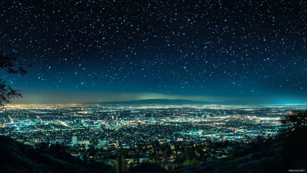 A sprawling City Night skyline glows under stars.