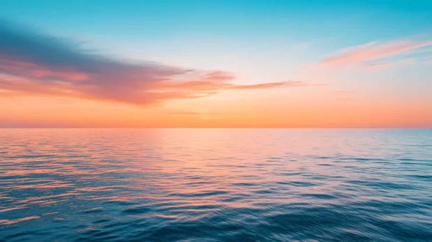 A time lapse photo of a sunset over the ocean.