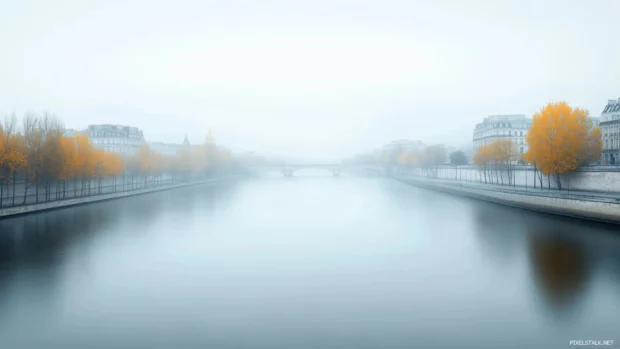 A tranquil scene of the Seine River with a faint outline of Parisian buildings in the background.