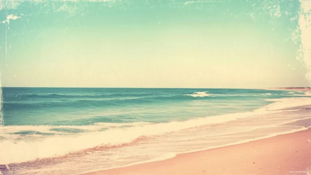 A vintage beach photo, with faded colors and a grainy texture.