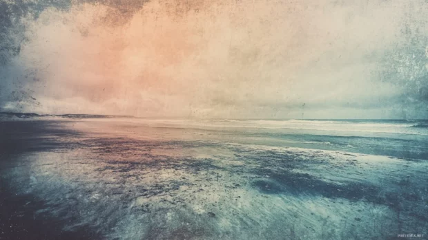 A vintage style photograph of a beach scene, with faded colors and a grainy texture.