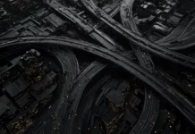 Aerial view of black city wallpaper with a network of shimmering highways.