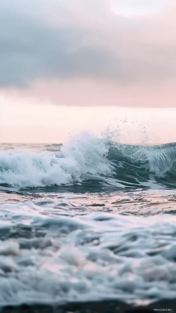 An aesthetic beach with soft waves gently crashing on the shore.