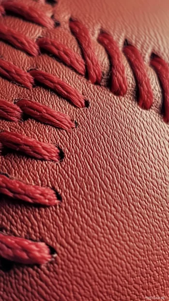 An intense close up of a baseball red stitching, emphasizing texture and intricate details.