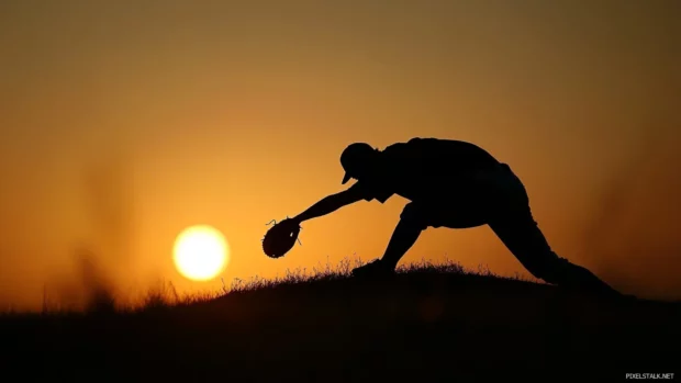 Baseball desktop wallpaper HD showing silhouette of pitcher on the mound.