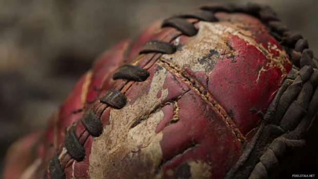 Baseball glove with chalk marks from an intense game.