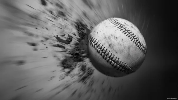 Baseball mid flight captured in grayscale with motion blur.